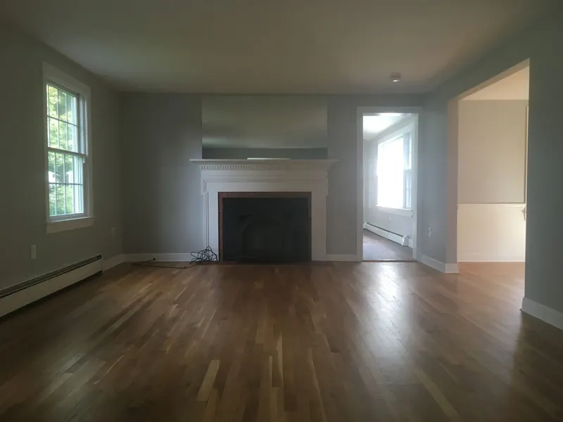 Freshly painted living room with fireplace and vaulted ceiling