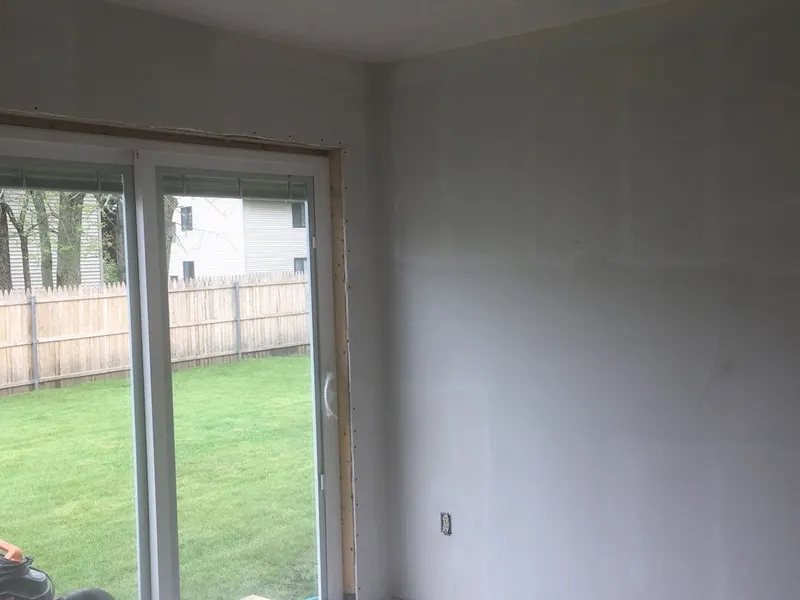 Freshly painted room with a sliding glass door to the backyard