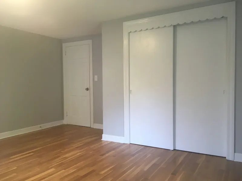 Freshly painted bedroom with white sliding closet doors