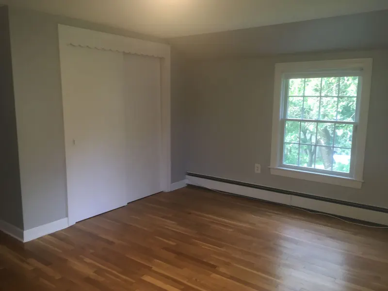Freshly painted bedroom with white trim and closet