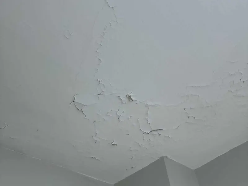 Cracked, peeling ceiling paint before repair