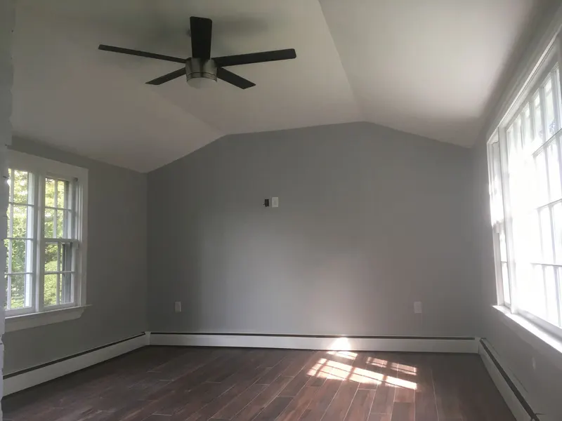 Freshly painted bedroom with vaulted ceiling and ceiling fan