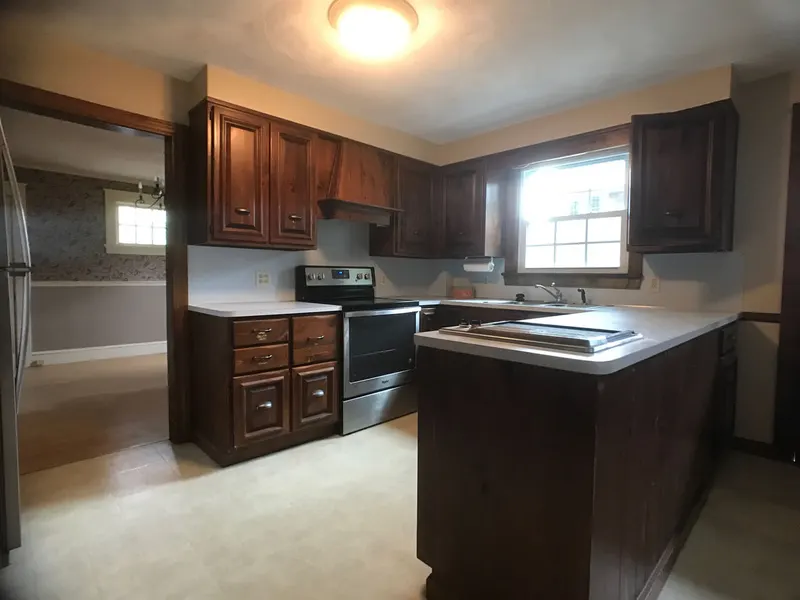 Kitchen with freshly painted walls and dark wood cabinets