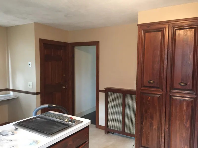 Freshly painted two-tone walls with stained wood doors and trim
