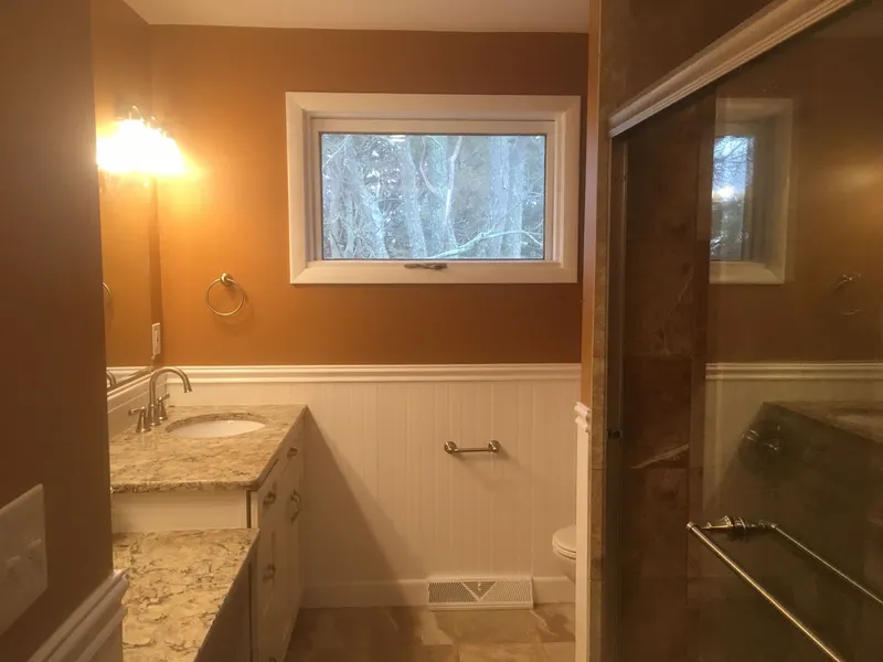 Bathroom with freshly painted walls above white wainscoting