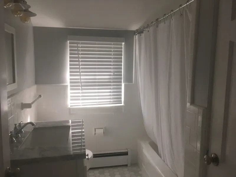 Freshly painted bathroom with white tile and window