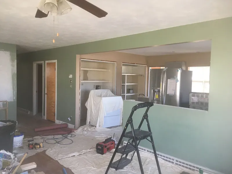 Room prepped with drop cloths at the start of an interior renovation