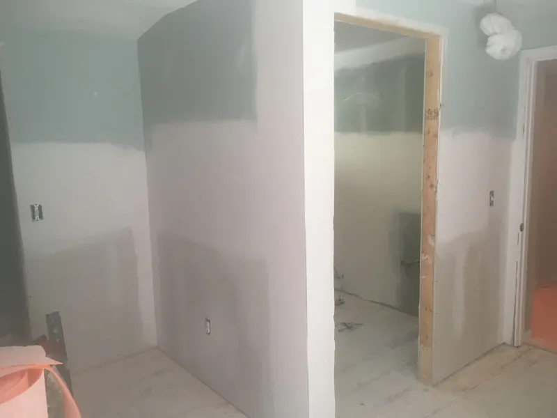 New drywall hung and mudded around a doorway