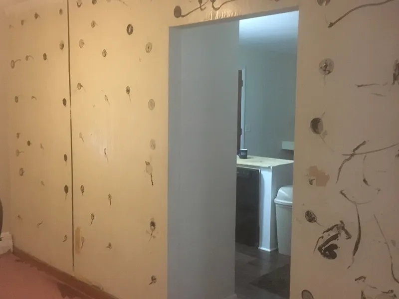 Wall patched with joint compound before skim coating