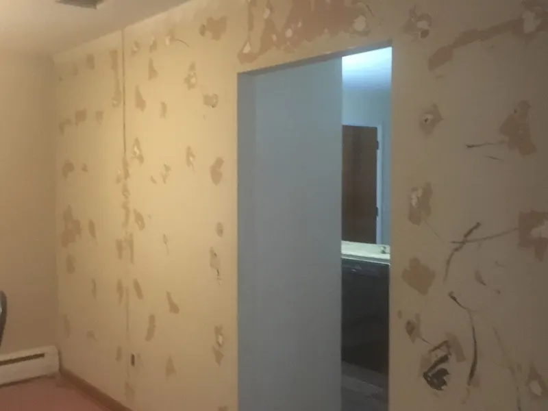 Patched holes on a wall before skim coating