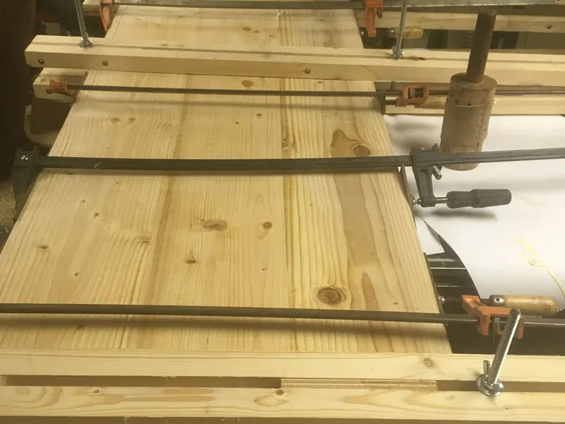 Pine boards clamped and glued up for a custom countertop