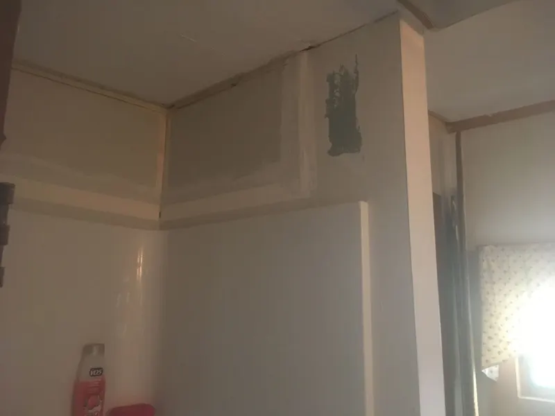 Bathroom wall prepped with new drywall above the tub surround