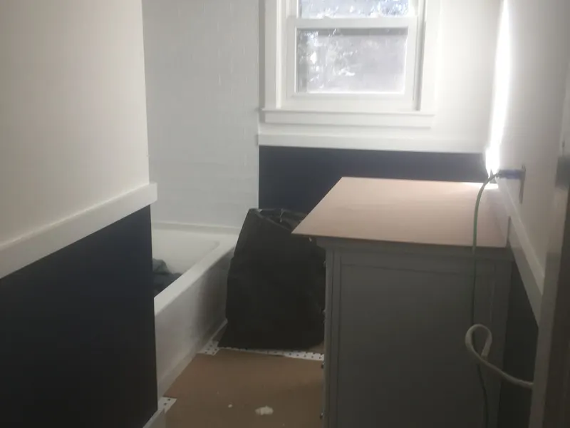 Bathroom with two-tone paint, black below and white above