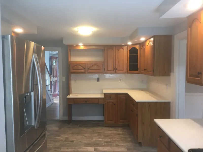 Kitchen with freshly painted walls and wood cabinets