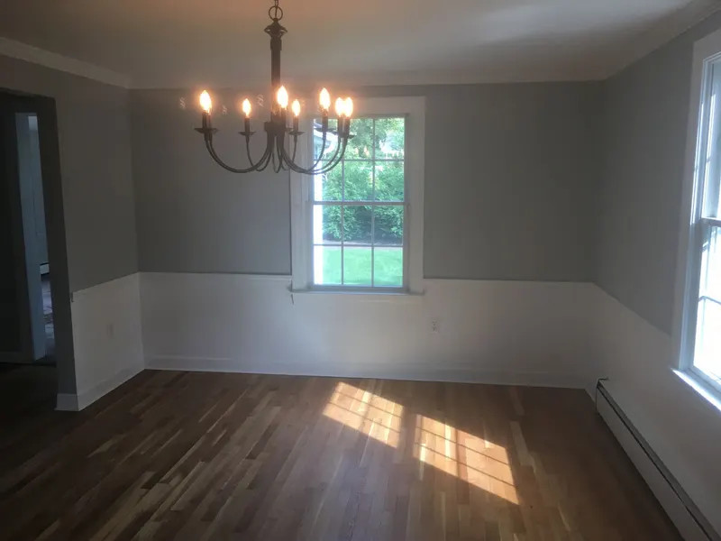 Dining room with fresh paint above white wainscoting