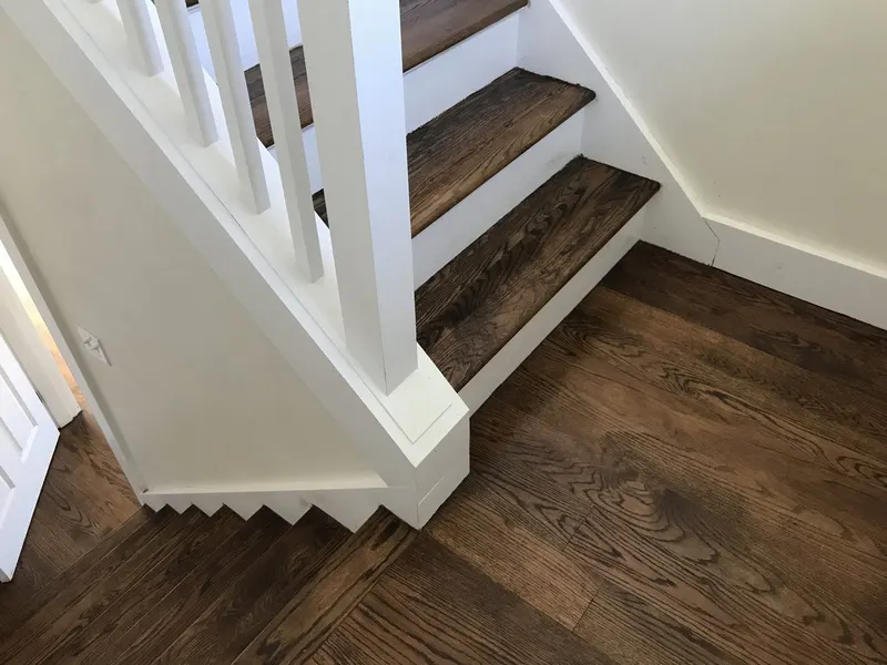 Staircase with painted white risers and stained treads