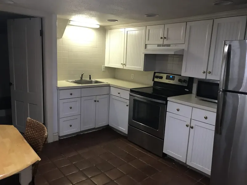 Kitchen with freshly painted white cabinets