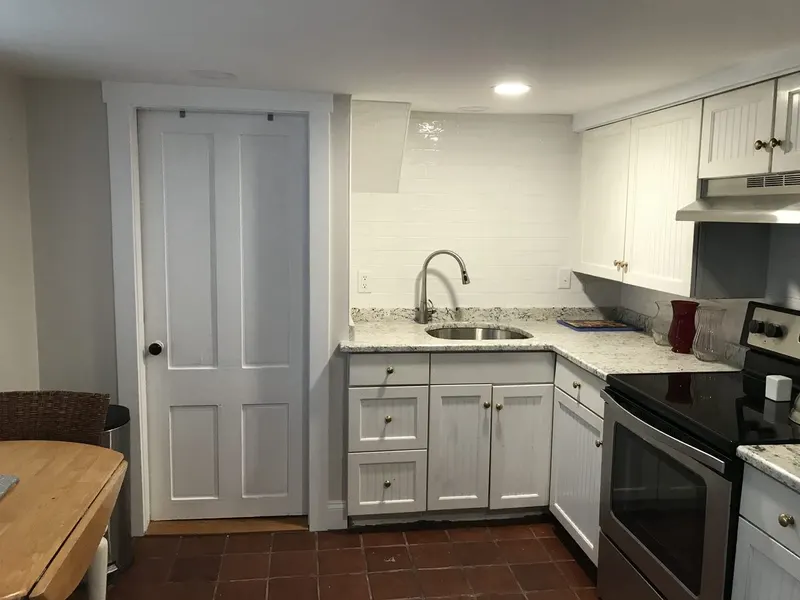 Kitchen with fresh white paint on cabinets, walls, and doors