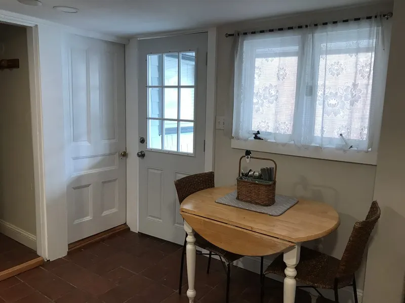 Kitchen nook with freshly painted walls, door, and trim