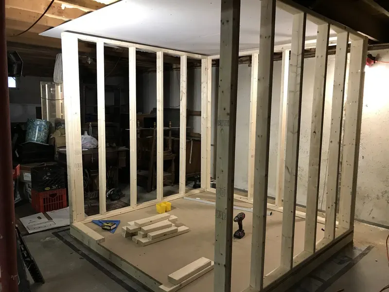 Recording booth framing going up in a basement