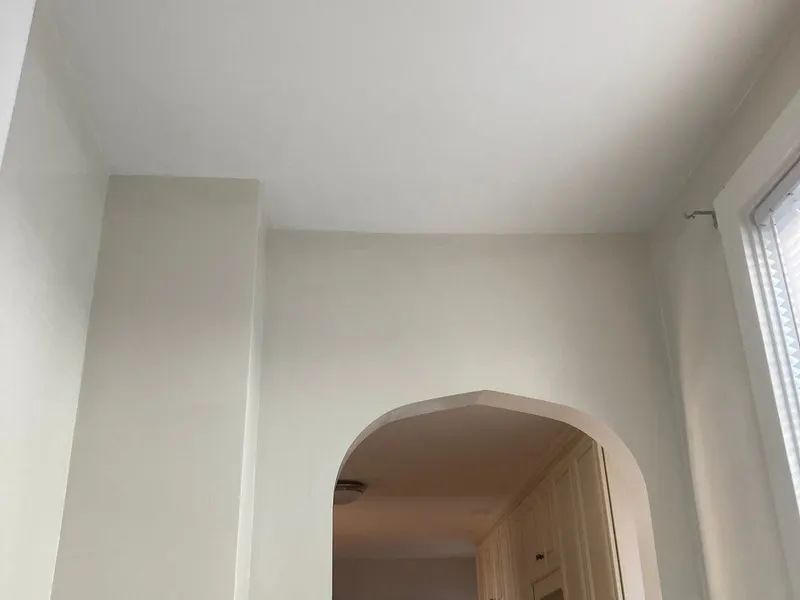 Finished smooth ceiling and walls around an arched doorway
