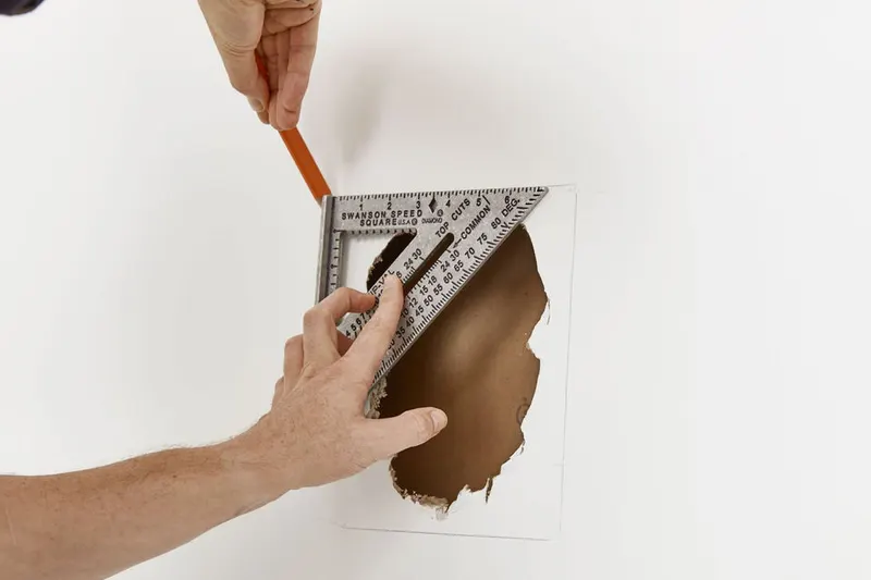 Marking a drywall hole for a clean repair patch